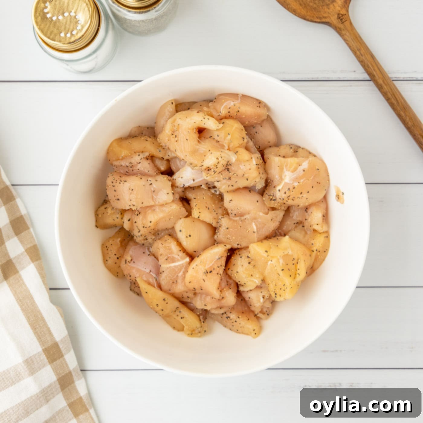 chicken seasoned with salt and pepper in a bowl
