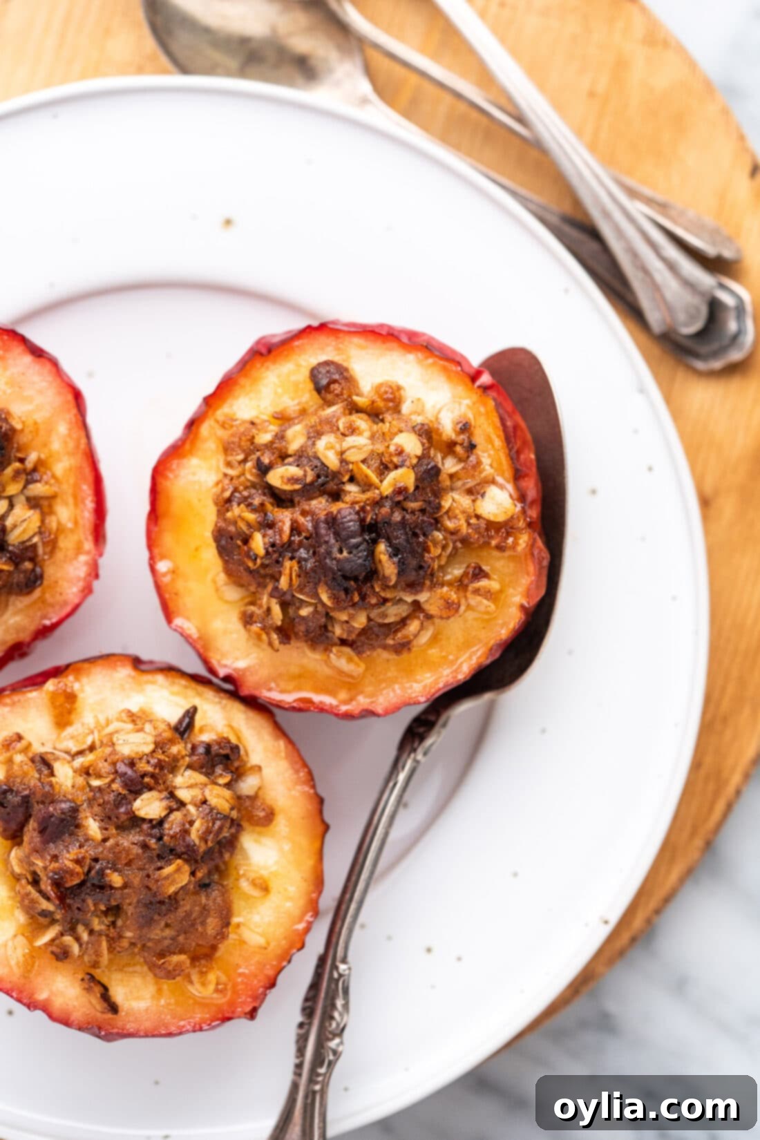 Air Fryer Baked Apples on a white plate, garnished with a sprinkle of cinnamon