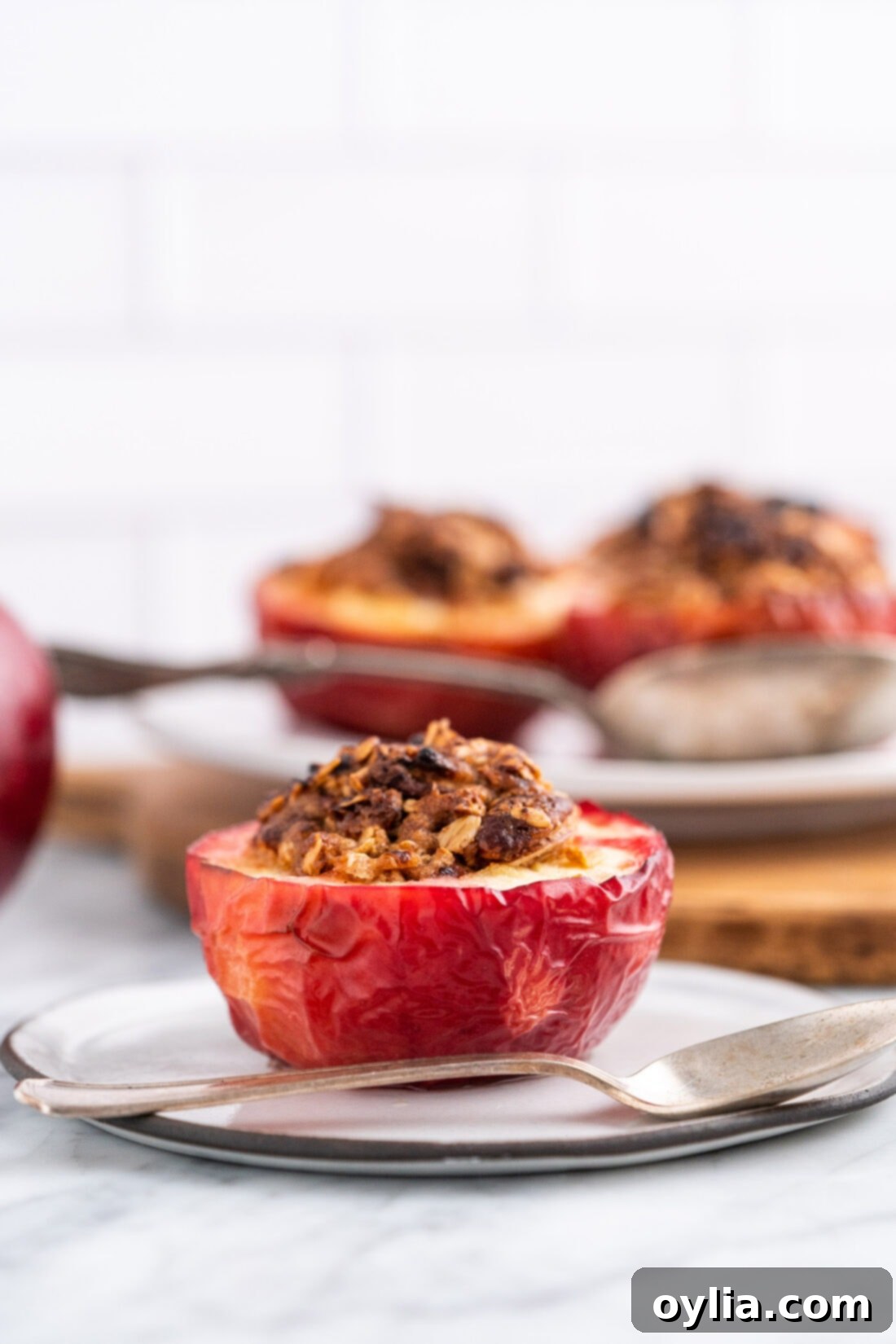 Air Fryer Apple Bliss 3 Close up of an Air Fryer Baked Apple on a plate with cinnamon