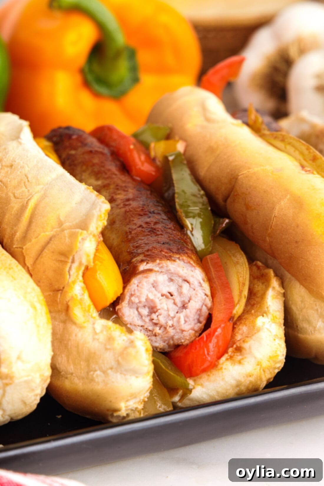 Rustic Sausage and Pepper Skillet 12 Sausage and Peppers on a bun with a bite out of it