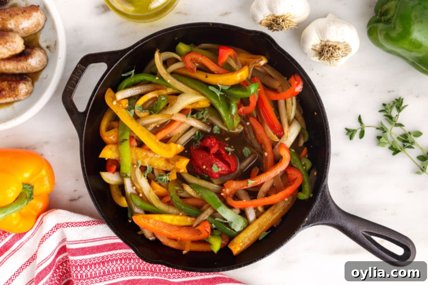 tomato paste added to peppers and onions in a skillet