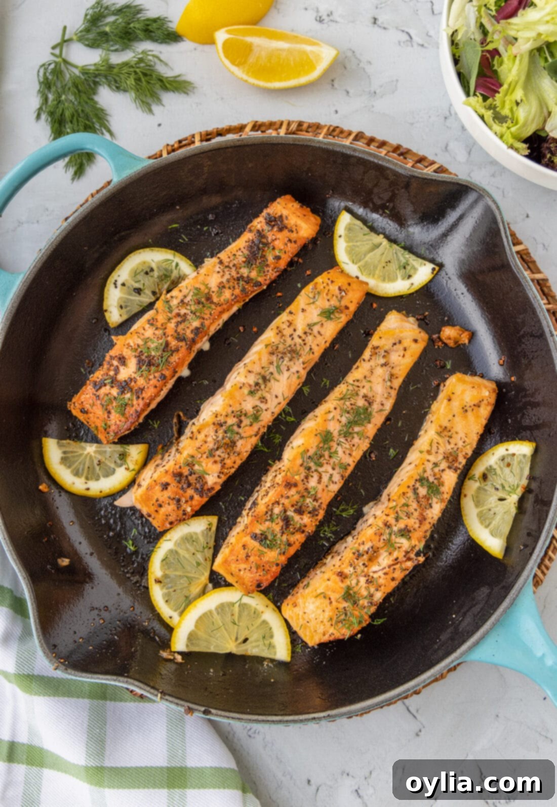 Pan Seared Salmon in a skillet with lemons