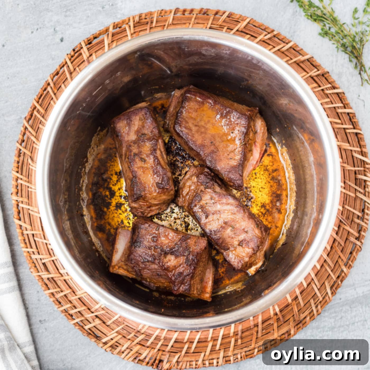 Searing beef short ribs in the Instant Pot, showing a golden brown crust