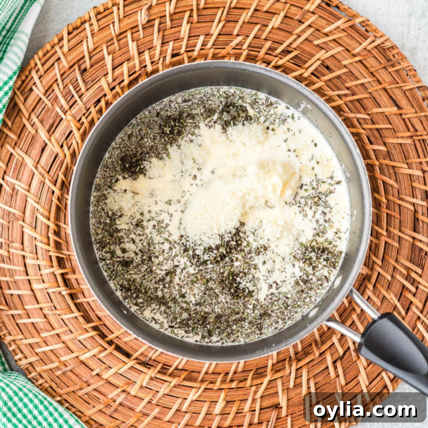 Rosemary cream sauce ingredients simmering in a saucepan