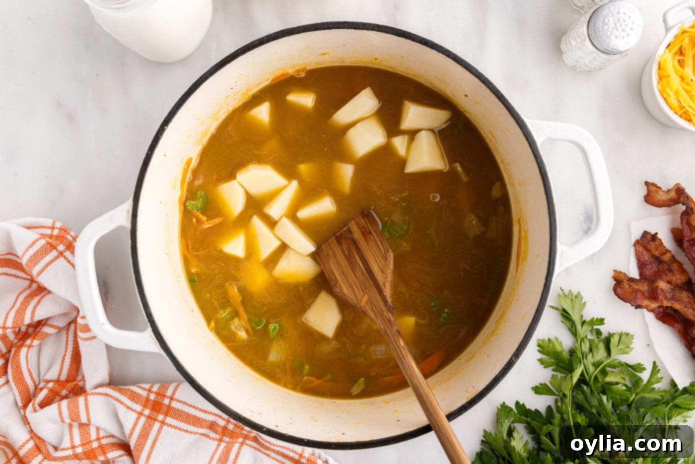 Cubed potatoes added to the stockpot with the soup base, ready to simmer