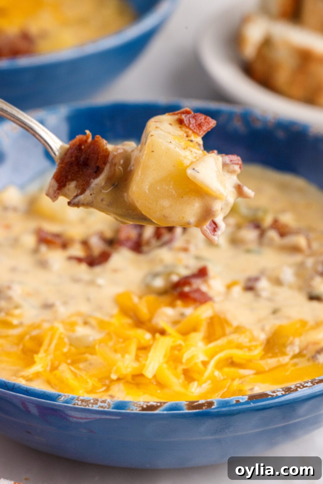 Spoonful of hearty Cheeseburger Soup with visible beef, potatoes, and vegetables