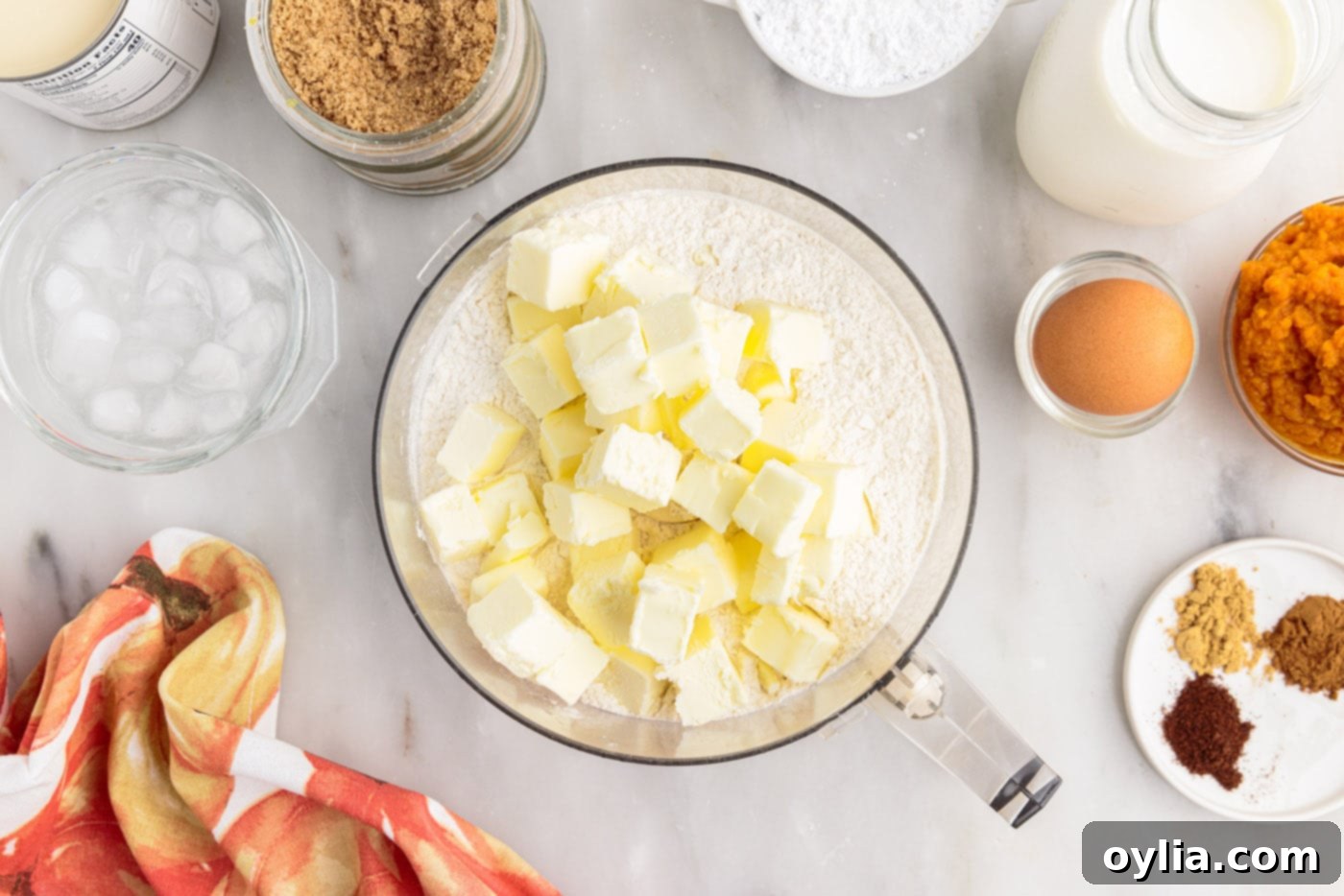 Cold butter cubes on top of flour mixture in a food processor bowl