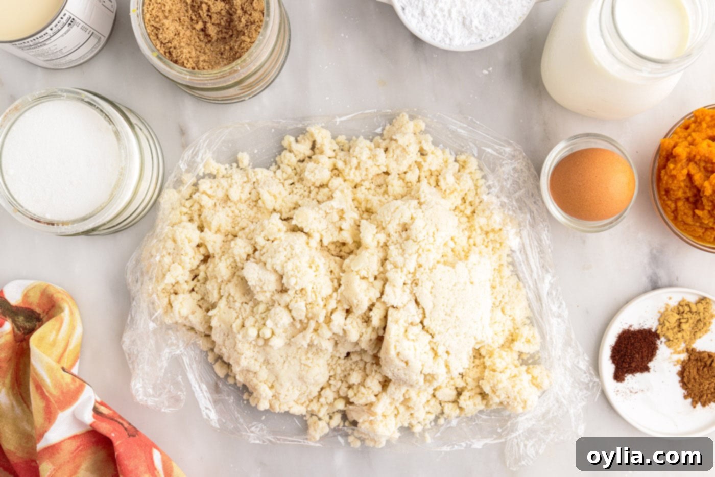 Pie dough placed on a sheet of plastic wrap