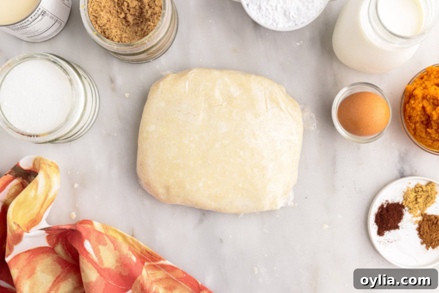 Homemade pie dough wrapped in plastic wrap, formed into a disc