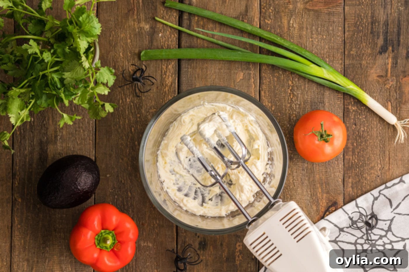 beating softened cream cheese with a hand mixer until creamy
