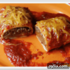 A close up photo of a Taco Bell enchirito copycat cut in half resting on a plate.