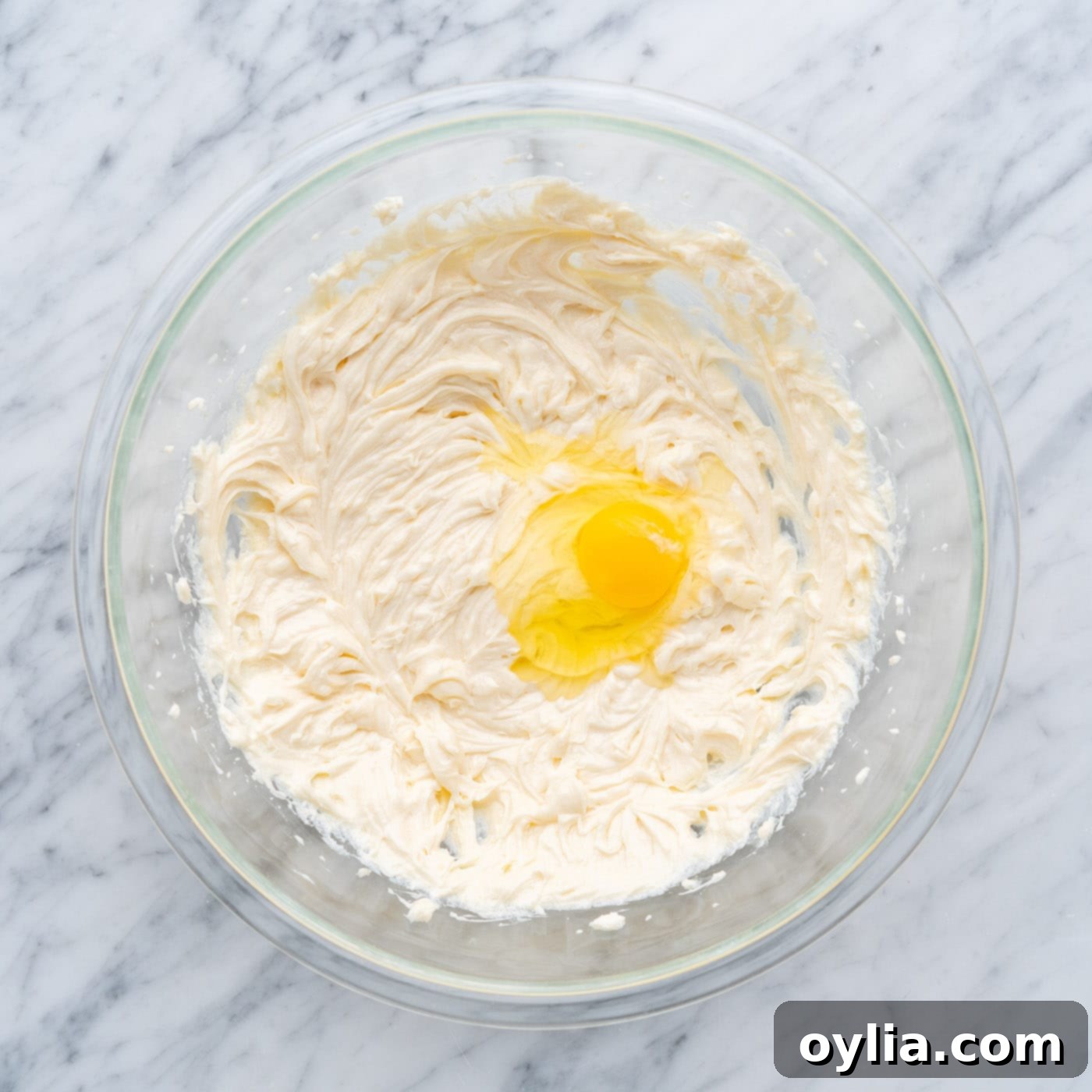 beating eggs into cream cheese mixture