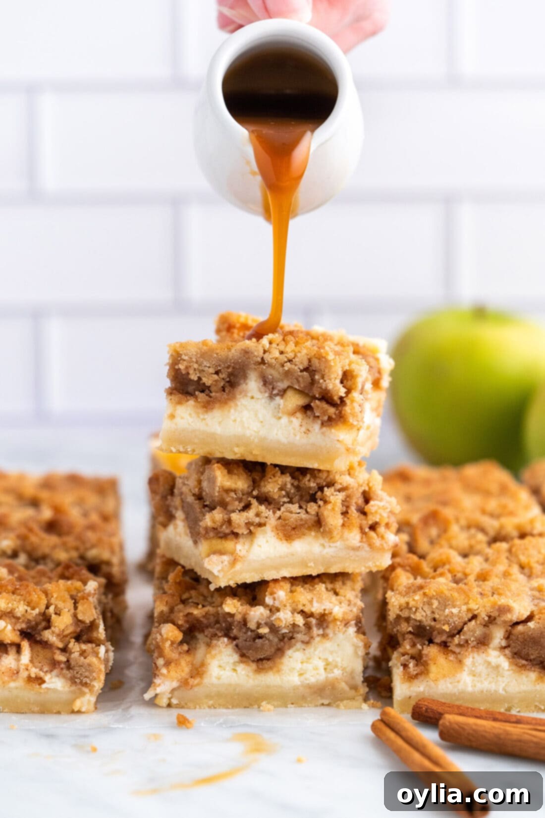 Golden Caramel Apple Cheesecake Squares 19 dripping caramel onto Caramel Apple Cheesecake Bars