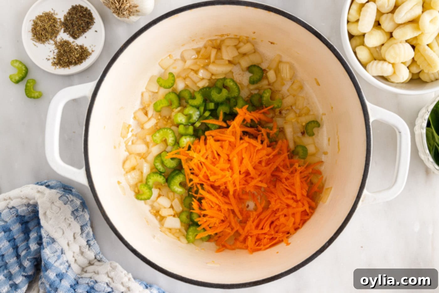 shredded carrots, celery, onion, and garlic in a stockpot