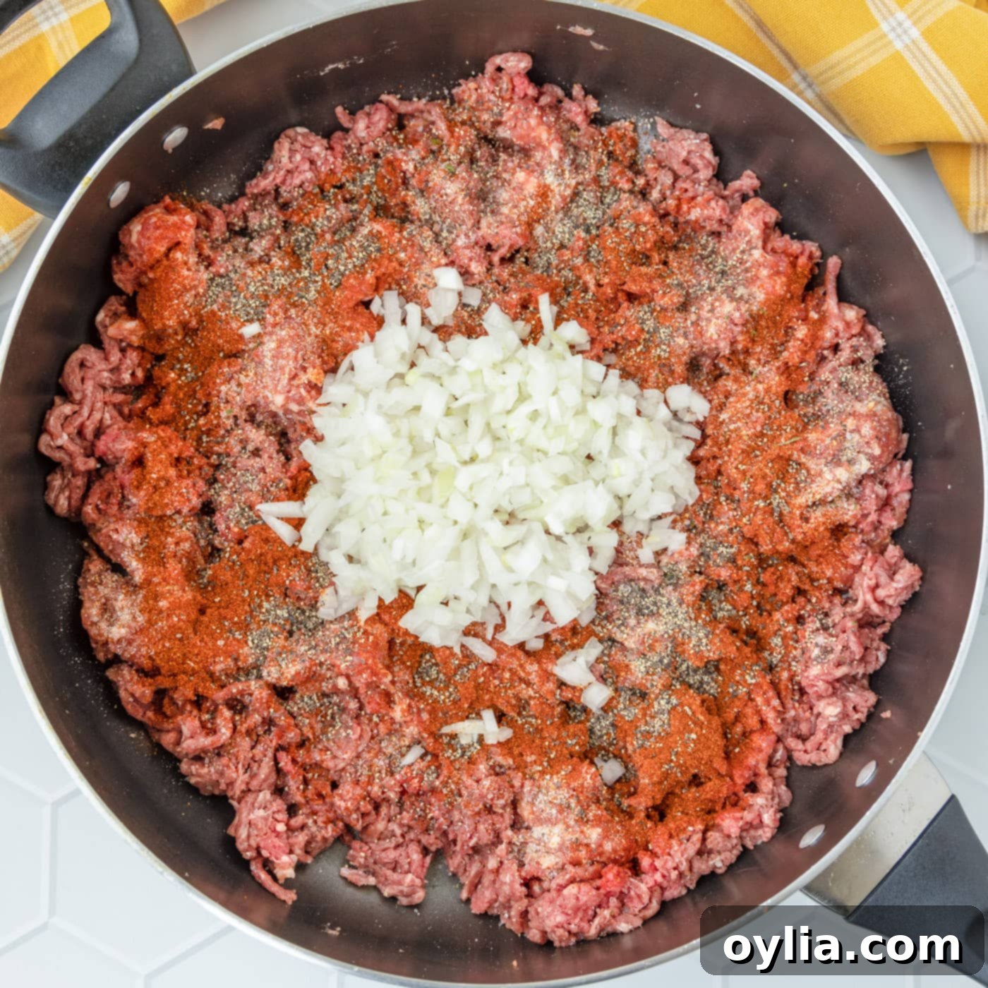 italian sausage, ground beef, onions, and seasoning browning in a skillet