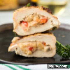 Stuffed Chicken Breast on a black plate, with a fork ready to enjoy