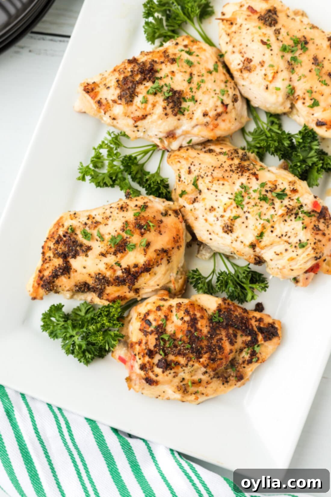 Platter of perfectly cooked Stuffed Chicken Breasts, golden brown and ready to serve