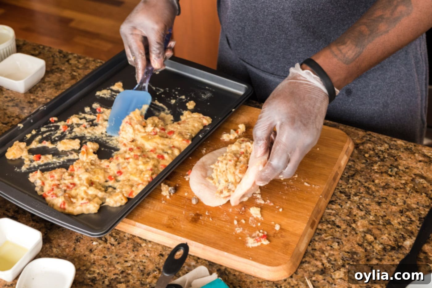 Stuffing a butterflied chicken breast with the savory filling, ready to be folded and secured