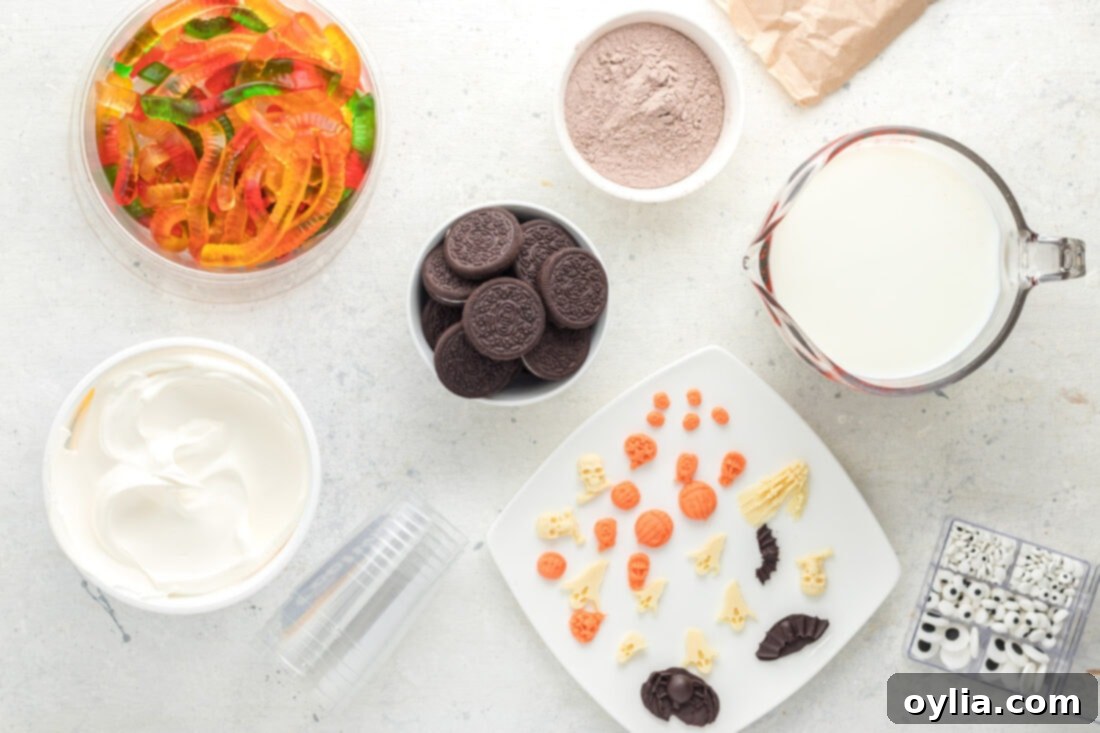 Ingredients for Halloween Dirt Cups laid out: instant pudding boxes, milk, Cool Whip, and a package of Oreos.