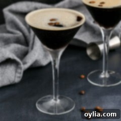 Velvet Buzz 9 A vibrant Espresso Martini with a rich frothy top, expertly garnished with three coffee beans.