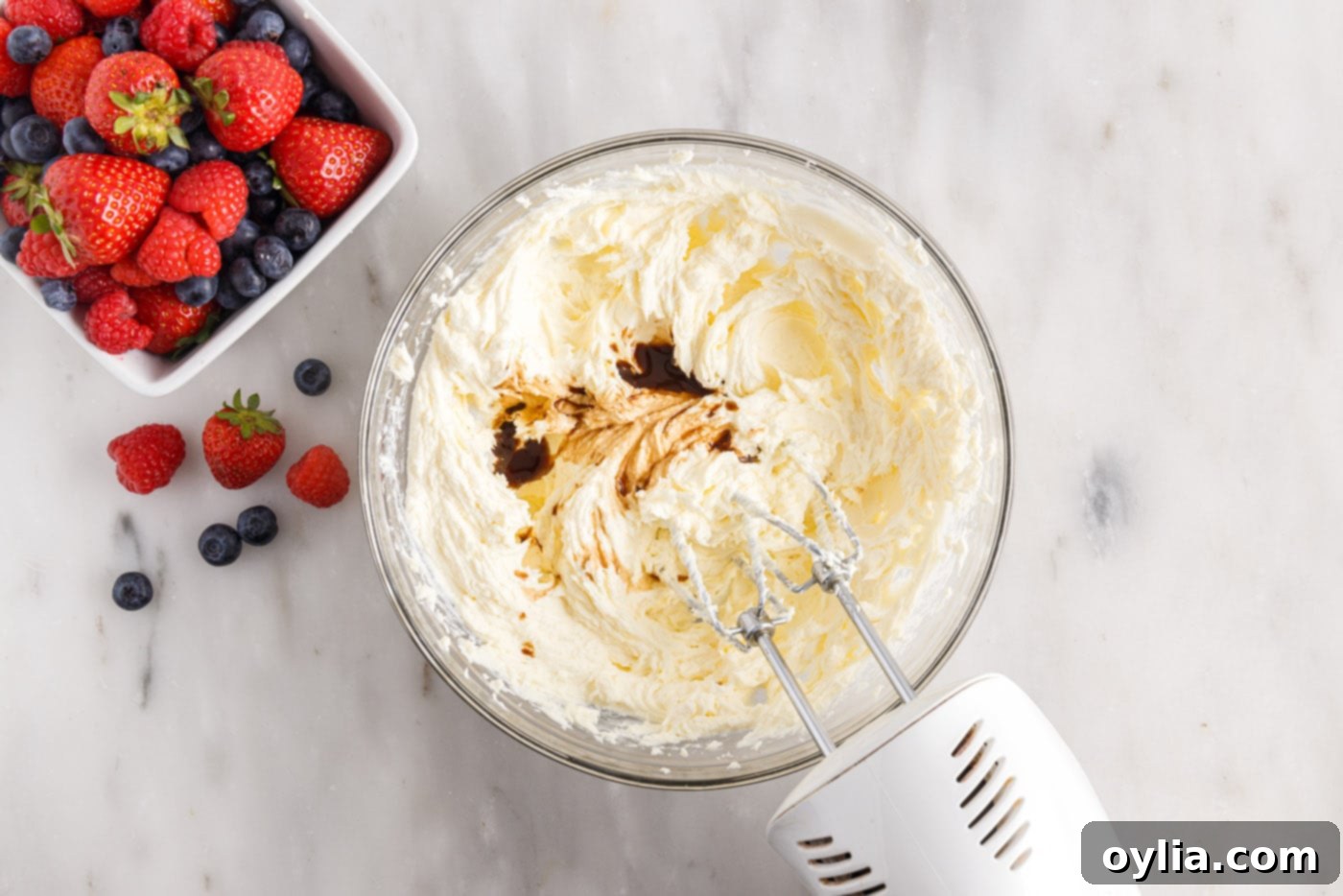 creaming chantilly frosting in a bowl