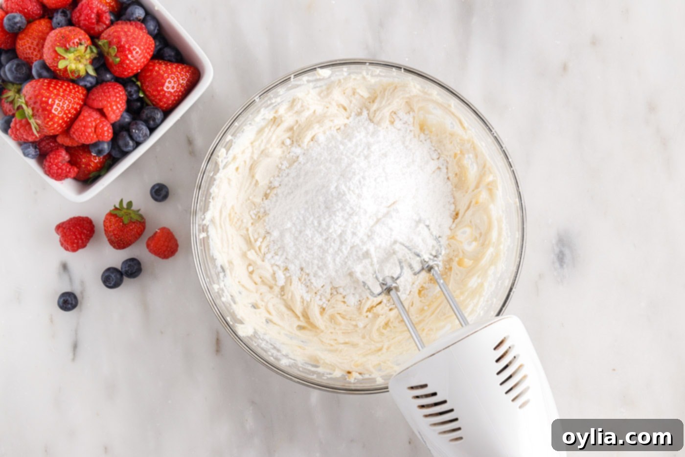 mixing powdered sugar into chantilly frosting