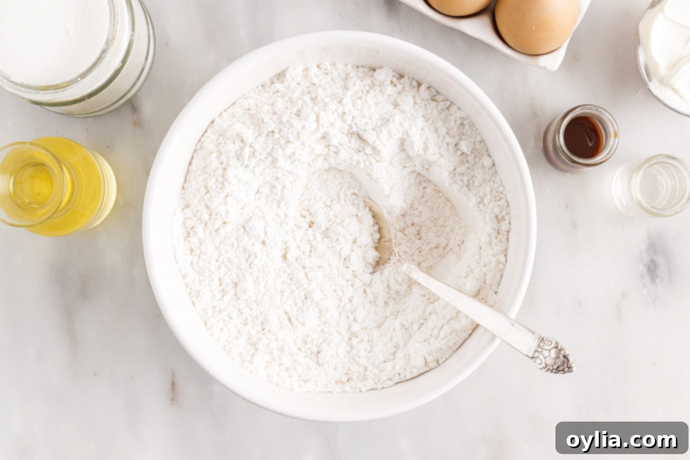 salt, baking powder, and baking soda mixed with flour in a bowl