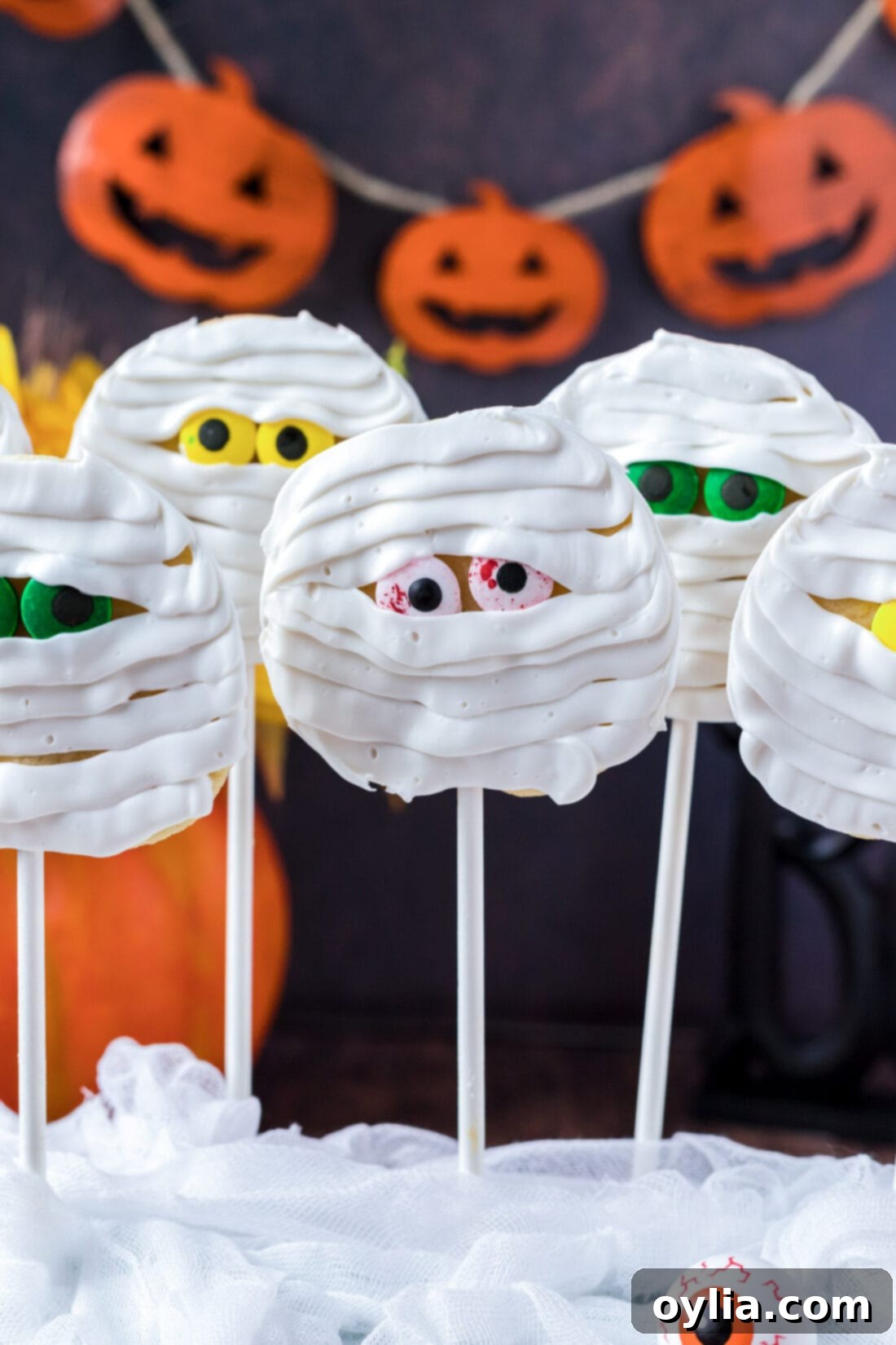 Spooky Bandage Bites 2 Mummy Cookies with pumpkin banner - Spooky-Sweet 4-Ingredient Halloween Treats