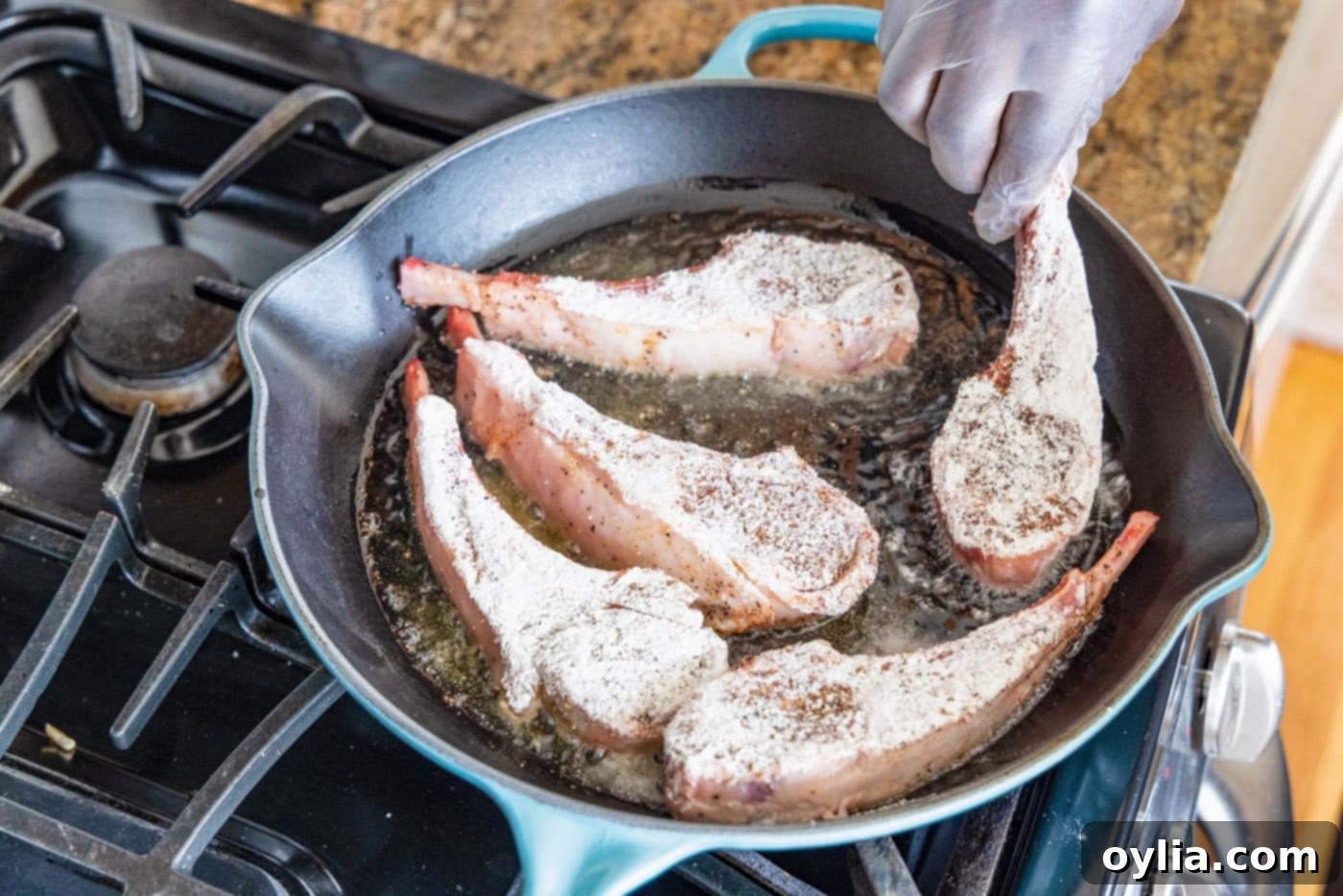 placing lamb chop in a skillet
