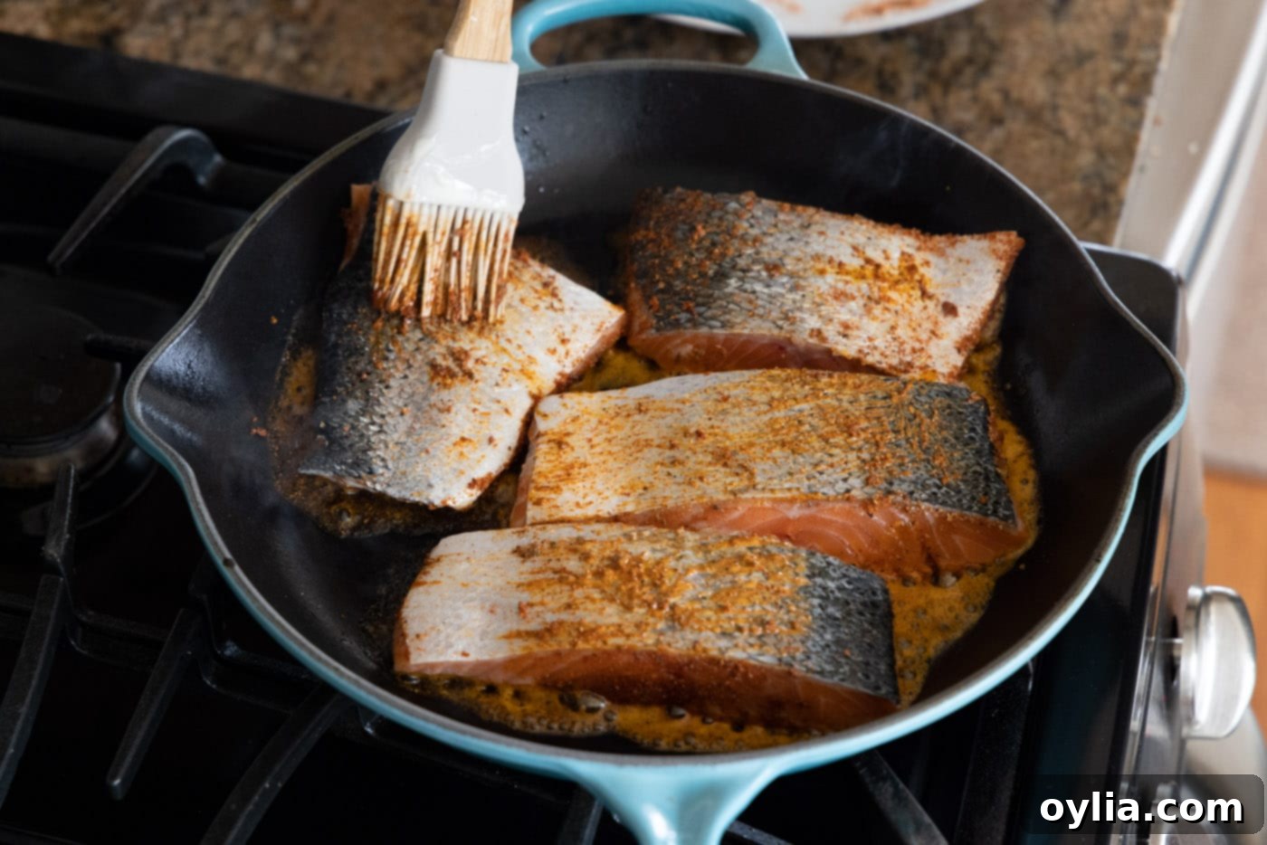 brushing salmon filets with butter