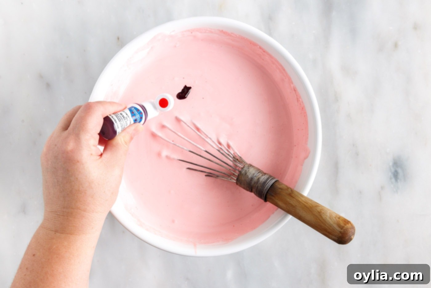 adding red food color to jello and whipped cream mixture