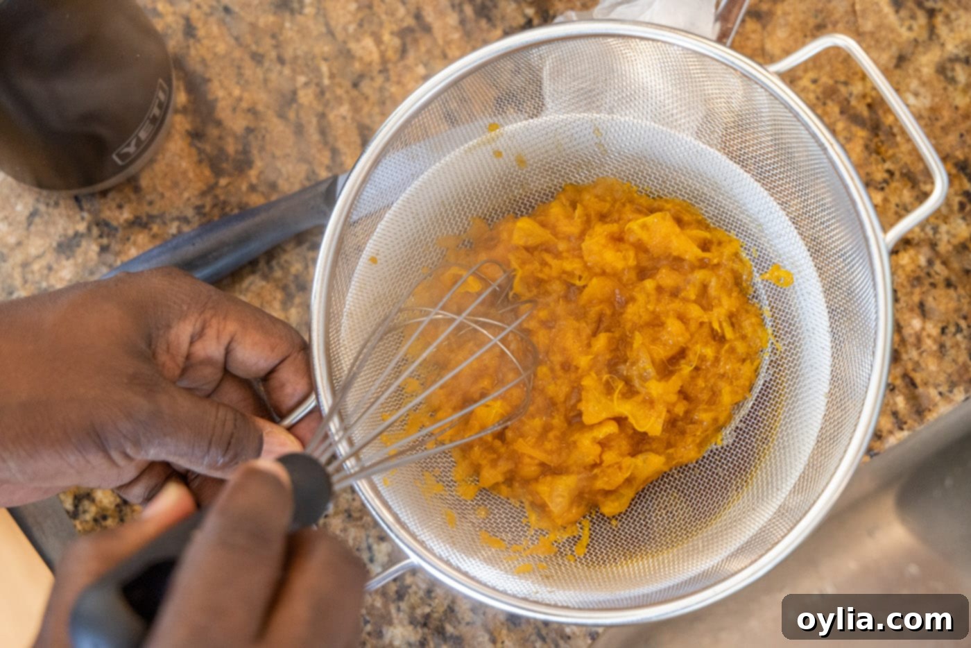 straining clementines from sauce