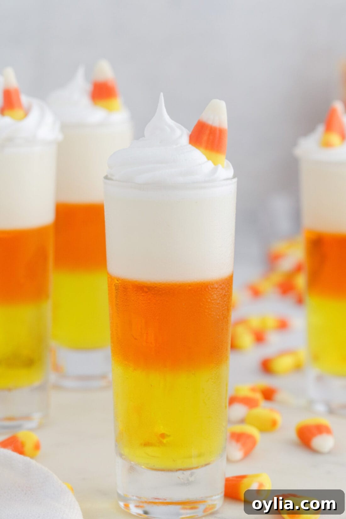 Festive Candy Corn Jello Shots with a Candy Corn Garnish for Halloween