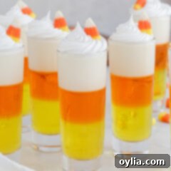 Candy Corn Jello Shots garnished with whip cream