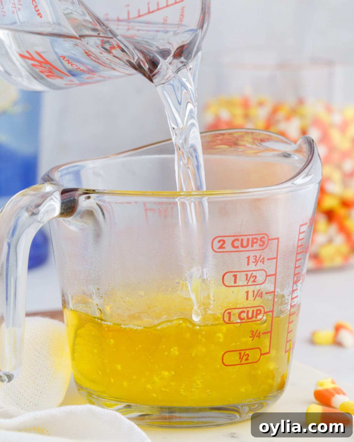 Pouring hot water into lemon jello mix in a bowl