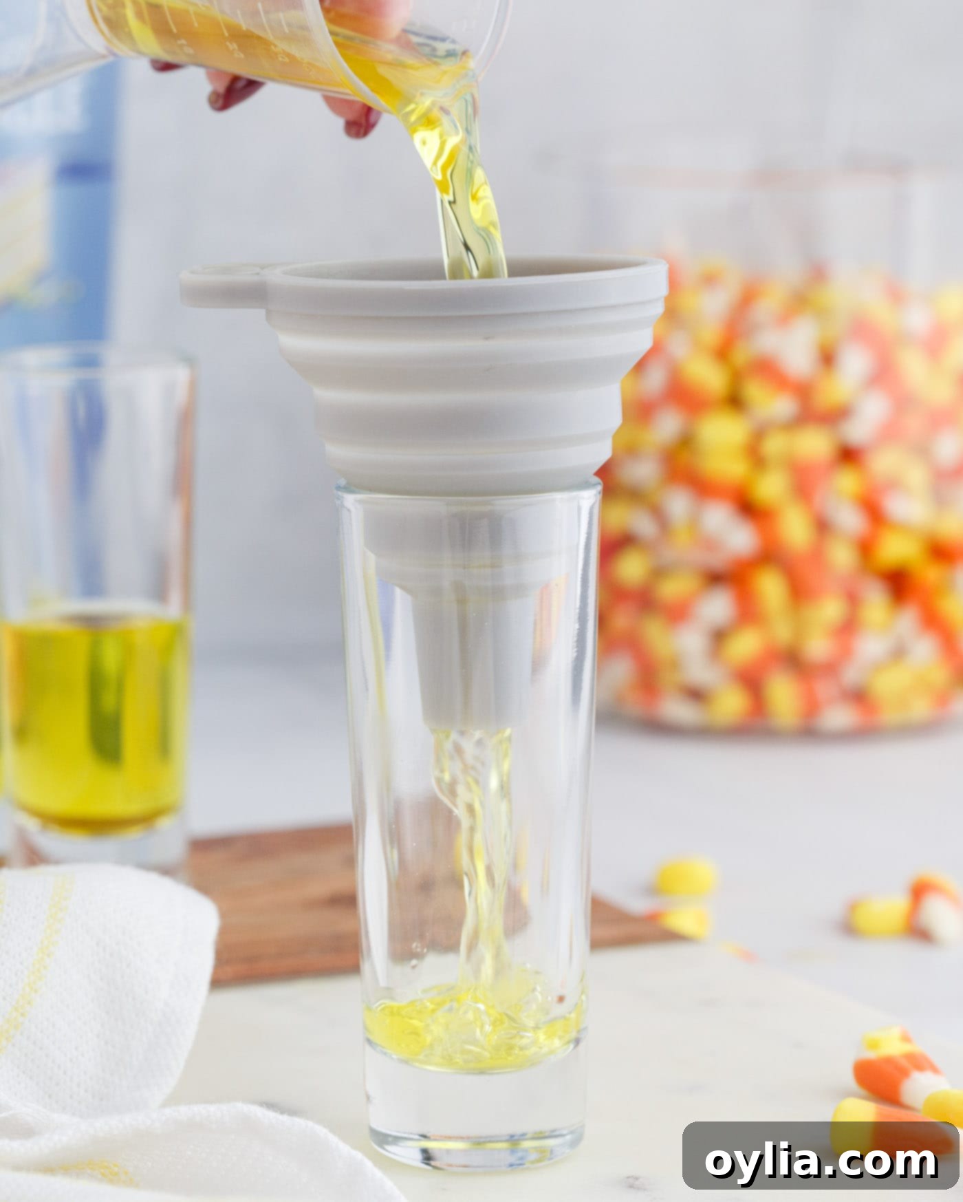 Carefully pouring lemon jello mix into small shot glasses