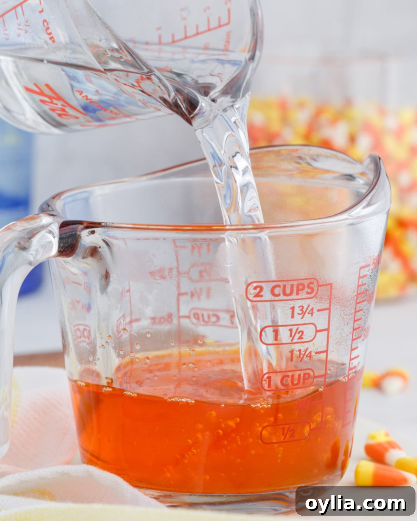 Whisking hot water into orange jello mix