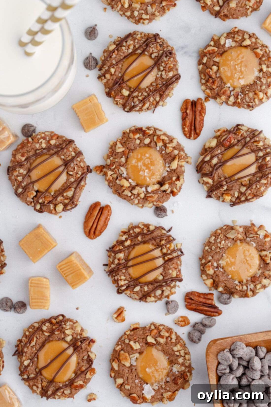 Beautifully arranged Turtle Thumbprint Cookies on a rustic wooden table, showcasing their chocolate base, caramel filling, and pecan crust.