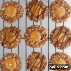 Perfectly baked Turtle Thumbprint Cookies cooling on a wire rack, ready to be enjoyed.