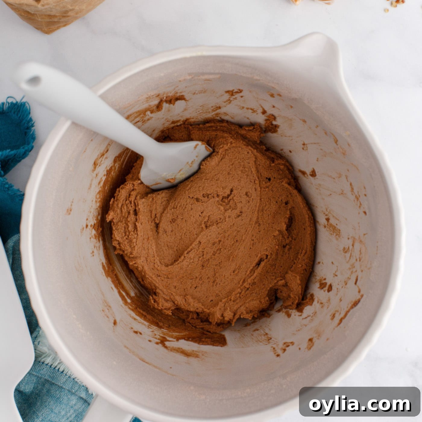 The fully mixed chocolate thumbprint cookie dough resting in a bowl, showing its rich color and thick consistency.