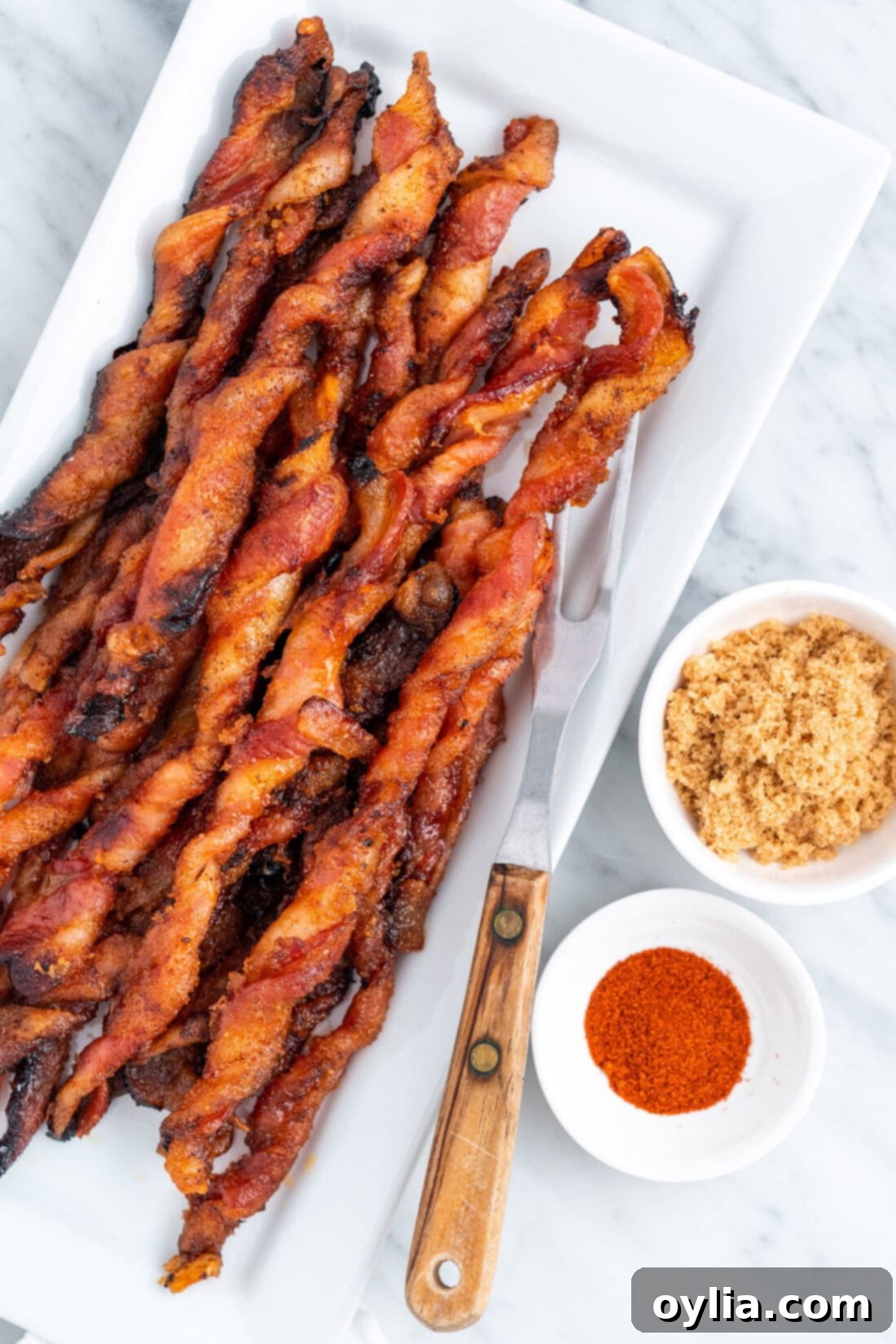 Bacon Twists on a platter, showcasing their sweet and spicy caramelized coating.