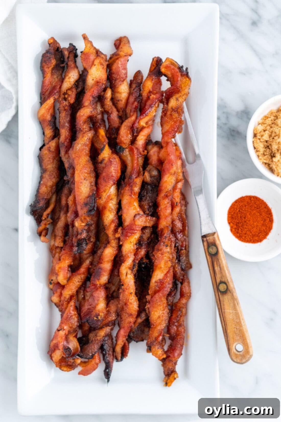 Platter of golden brown, sweet and spicy bacon twists, ready to be enjoyed.