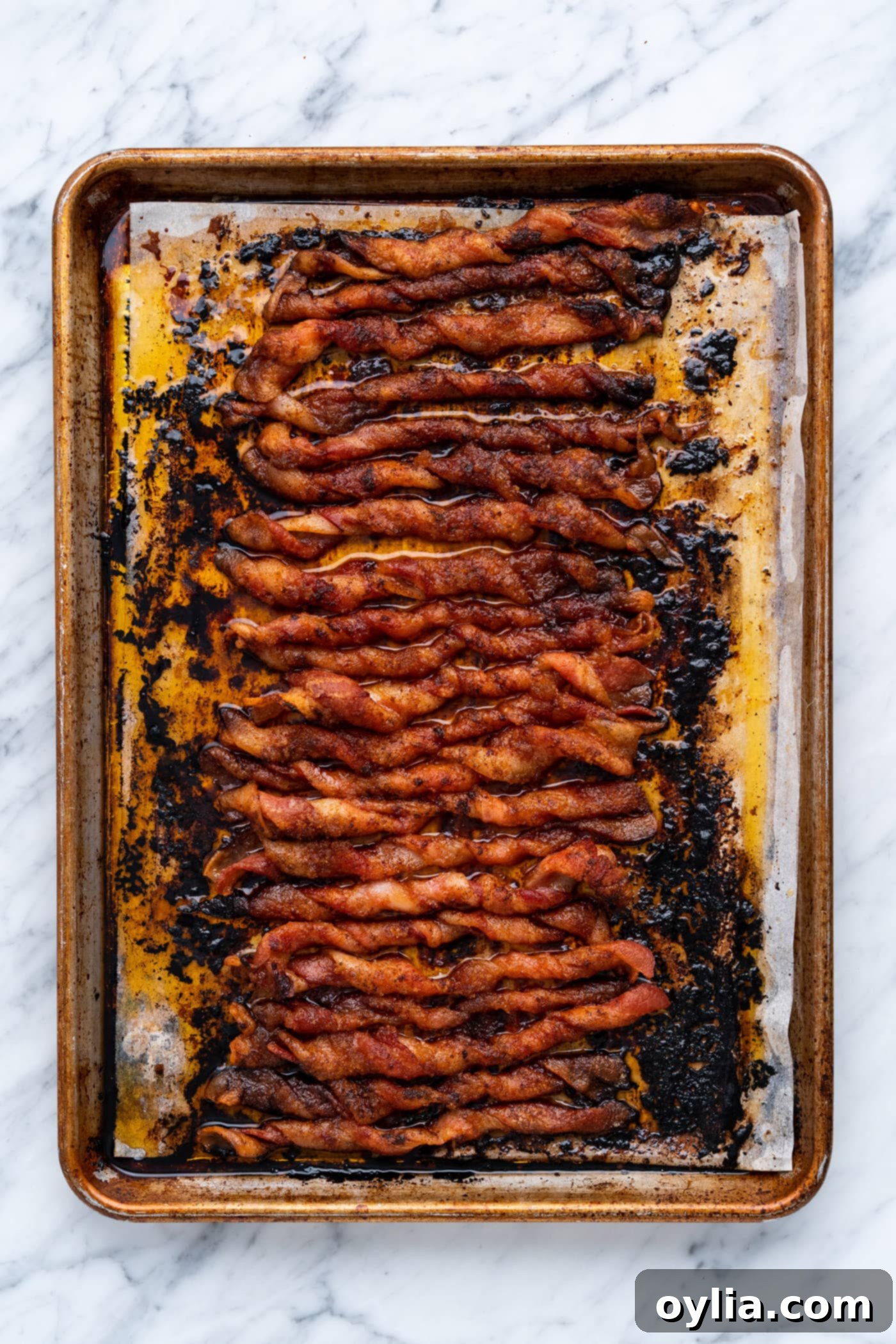 Oven-baked bacon twists, golden brown and caramelized, fresh out of the oven.