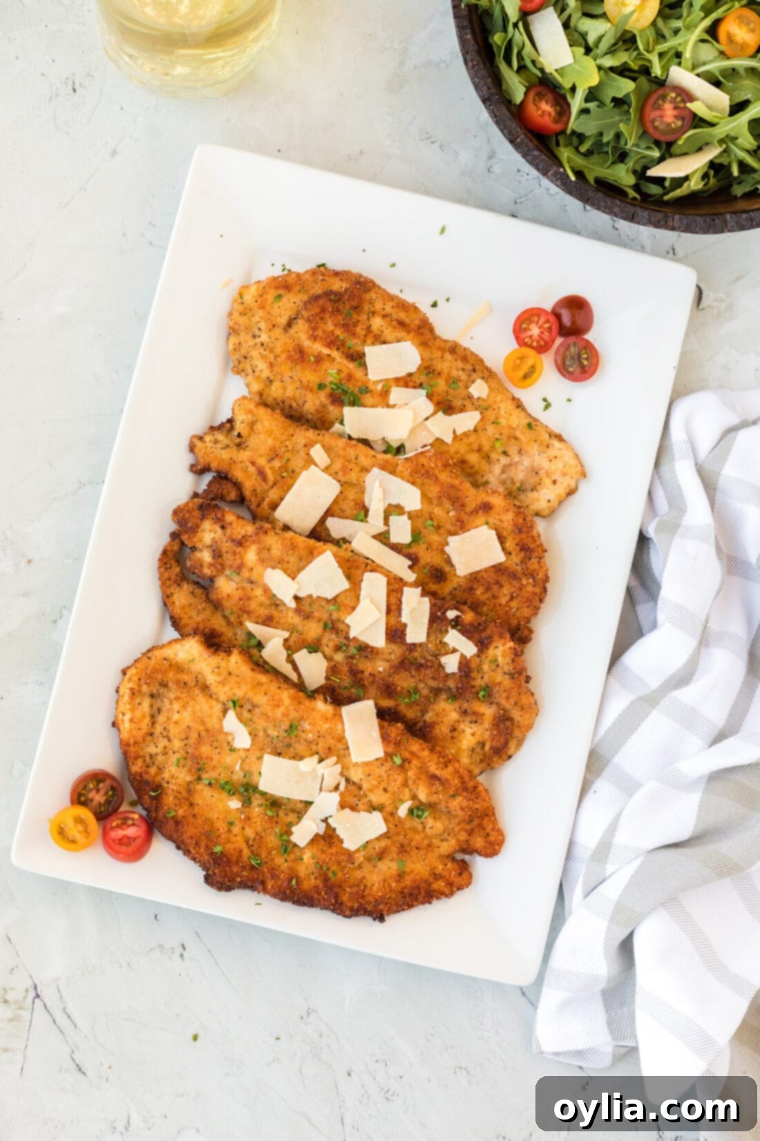 Platter of golden brown, crispy Chicken Milanese cutlets, ready to serve