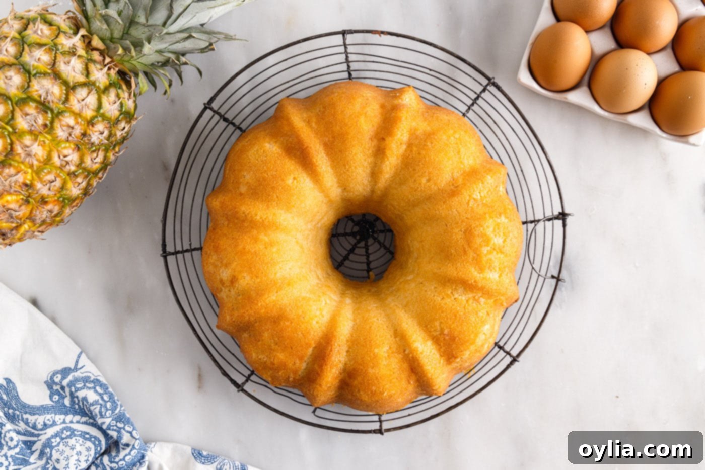 Freshly baked pineapple pound cake cooling on a wire rack