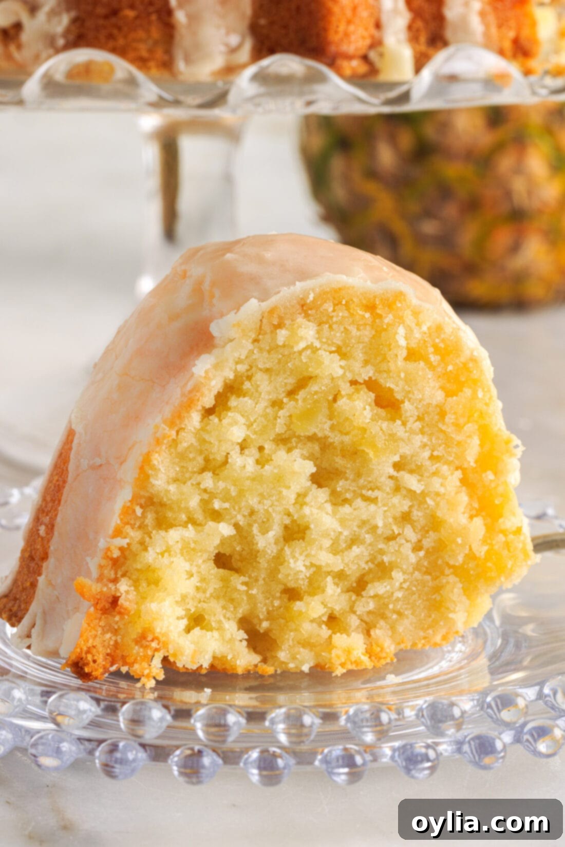 A perfectly baked slice of Pineapple Pound Cake with glaze