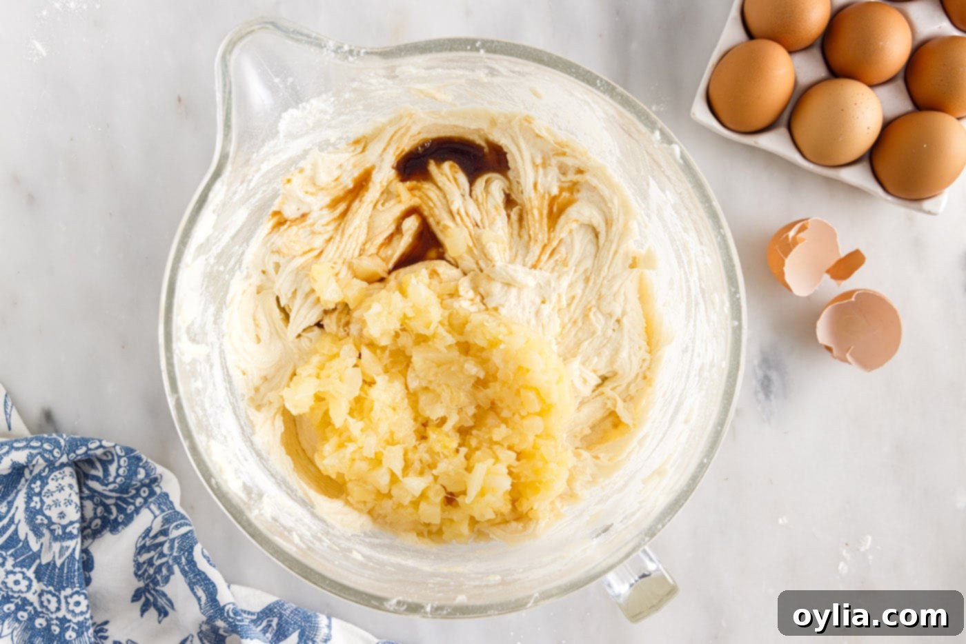 Pineapple and vanilla extract being added to the pound cake batter