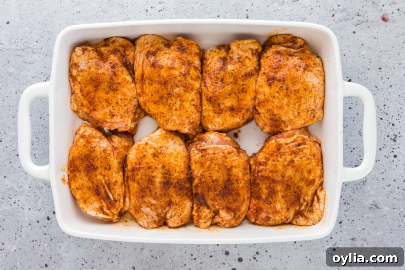 seasoned chicken thighs in a baking dish