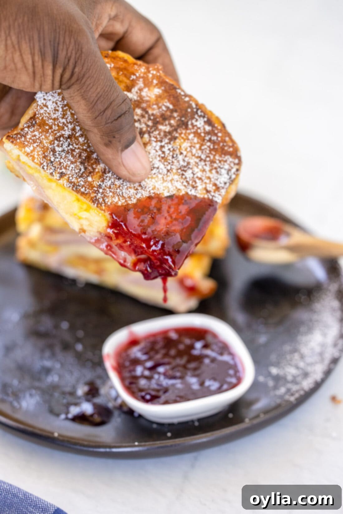 dipping a Monte Cristo Sandwich in jelly