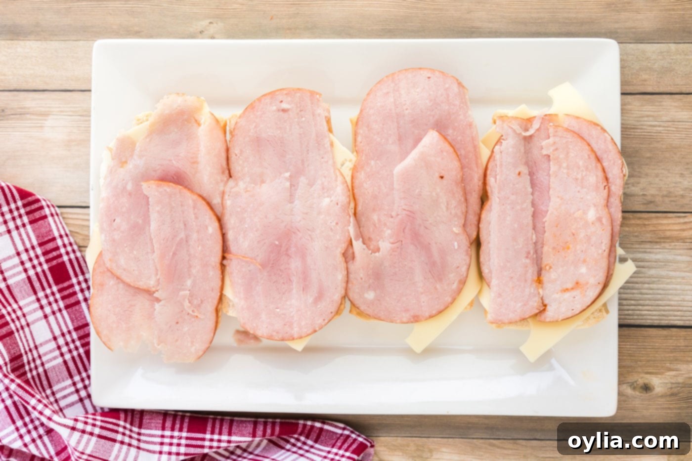 Deli ham slices added on top of the Swiss cheese and Cuban bread